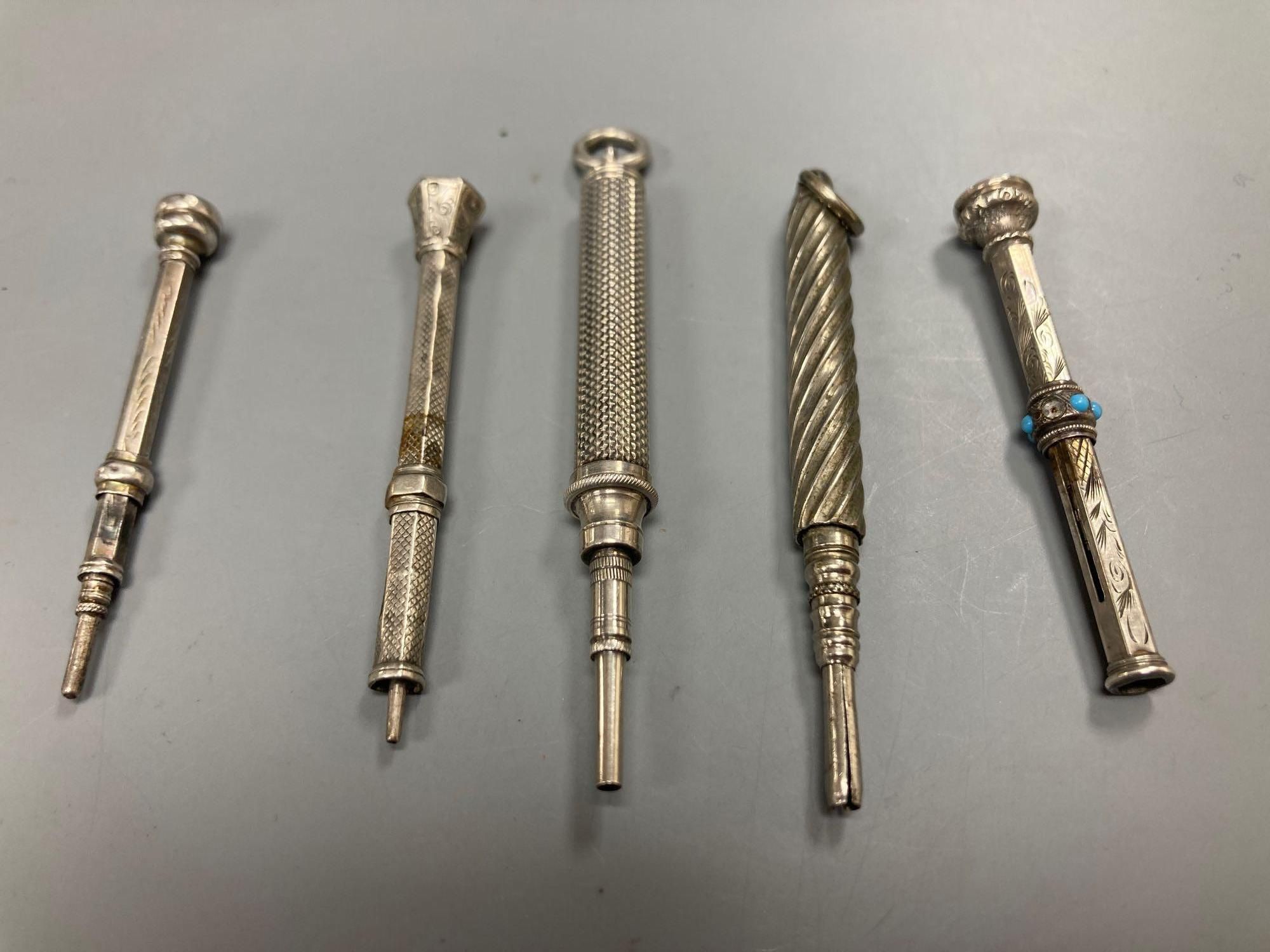 Five white metal propelling pencils and a collection of watch keys